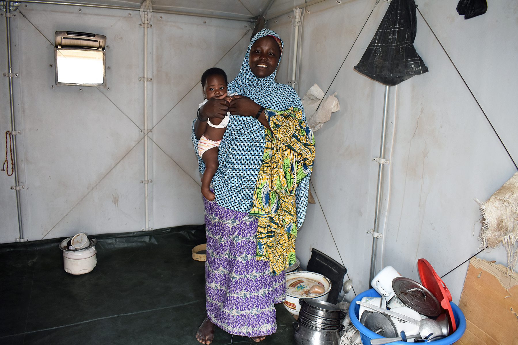 Chad. Aie and her three children in their Refugee Housing Unit (RHU) in Dar-es-Salam Refugee Camp