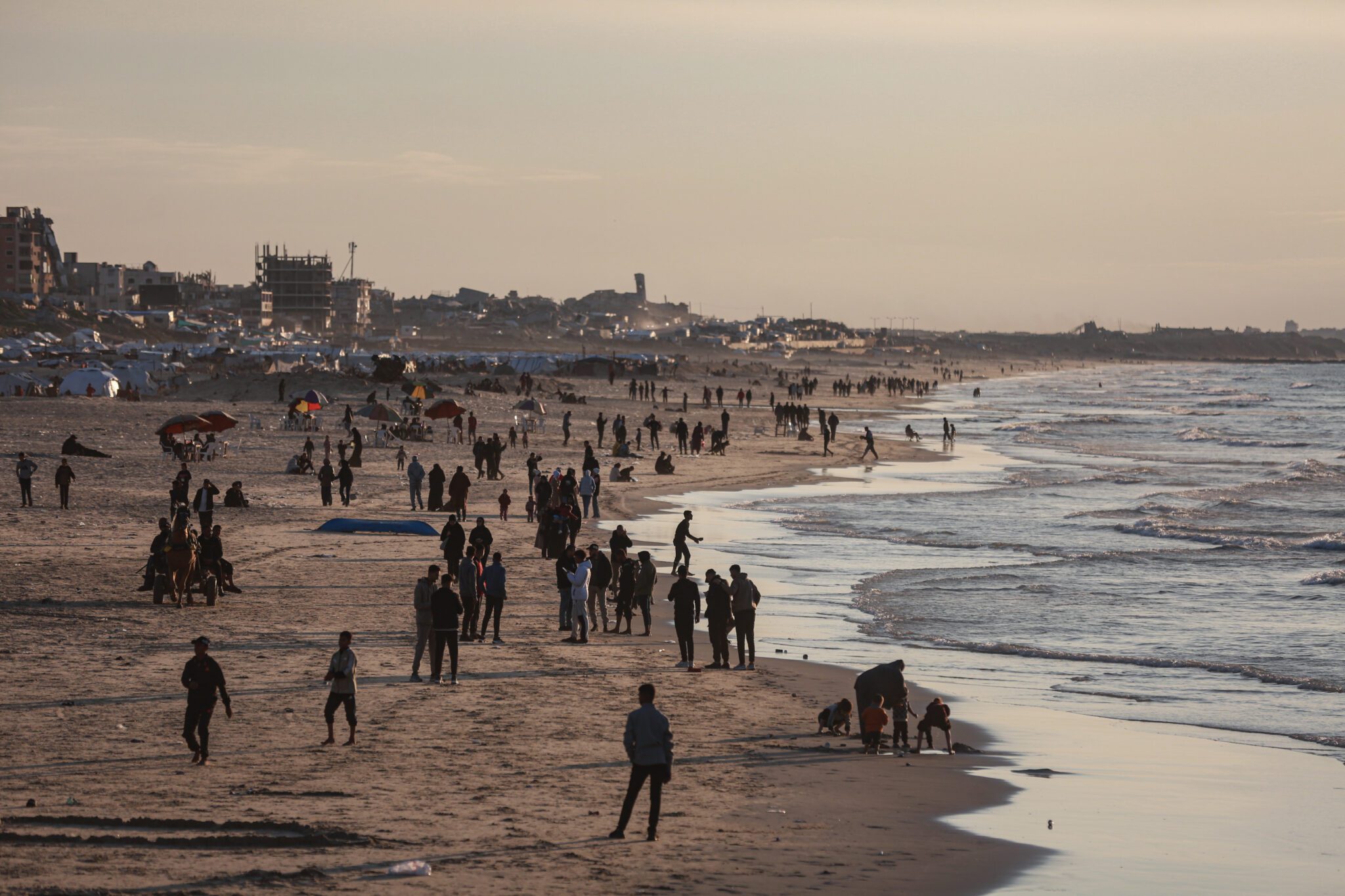 Shelters enter Gaza palestinians enjoy their mediterranean coastline