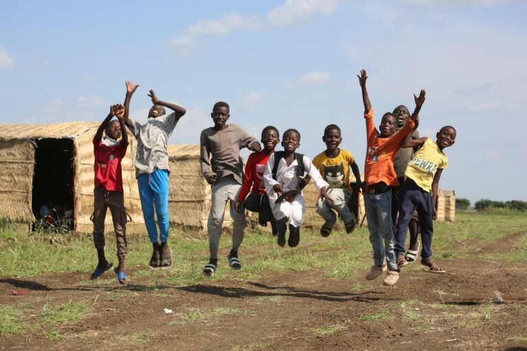 Save the Children builds shelters in Sudan ch11187583 joyful children at abunaja settlement gedaref, offering them save & secure environment